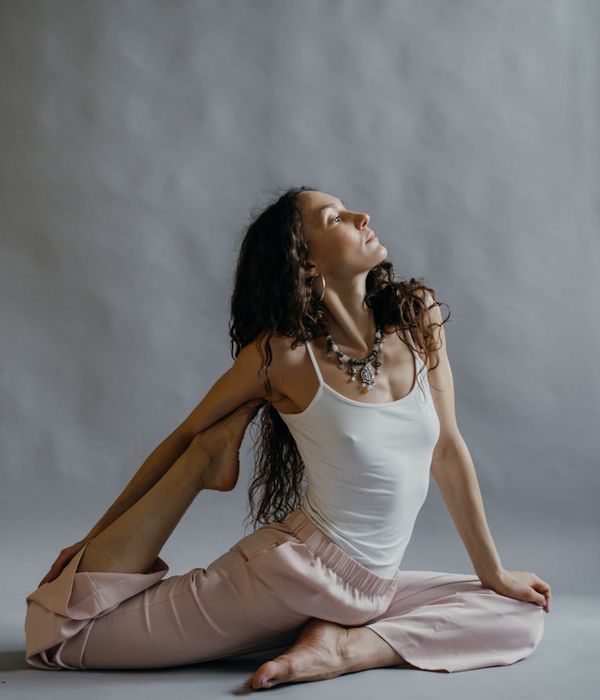 Woman in a graceful yoga pose, finding her inner harmony.